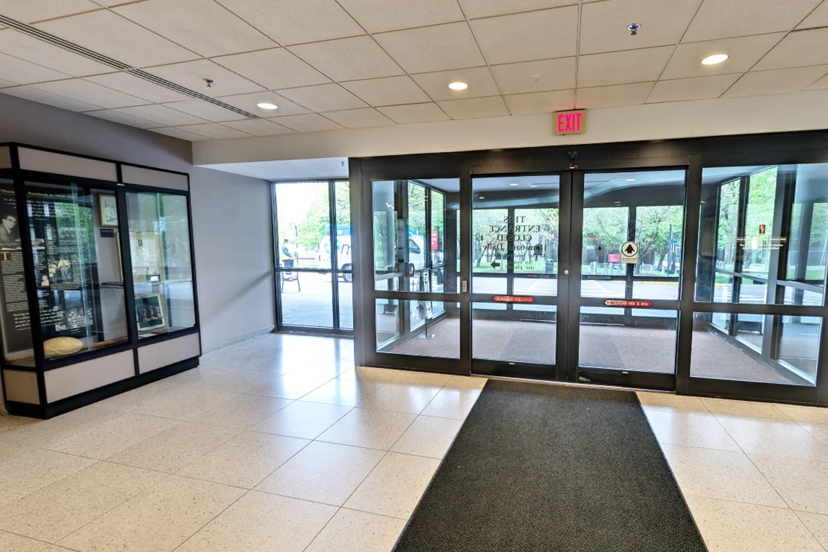 Front doors and historical display case in the lobby of PCOM's Rowland Hall