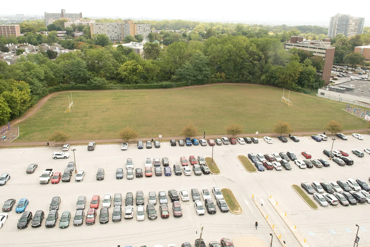 Aerial view of the grass sports field and walking trail off of Monument Road
