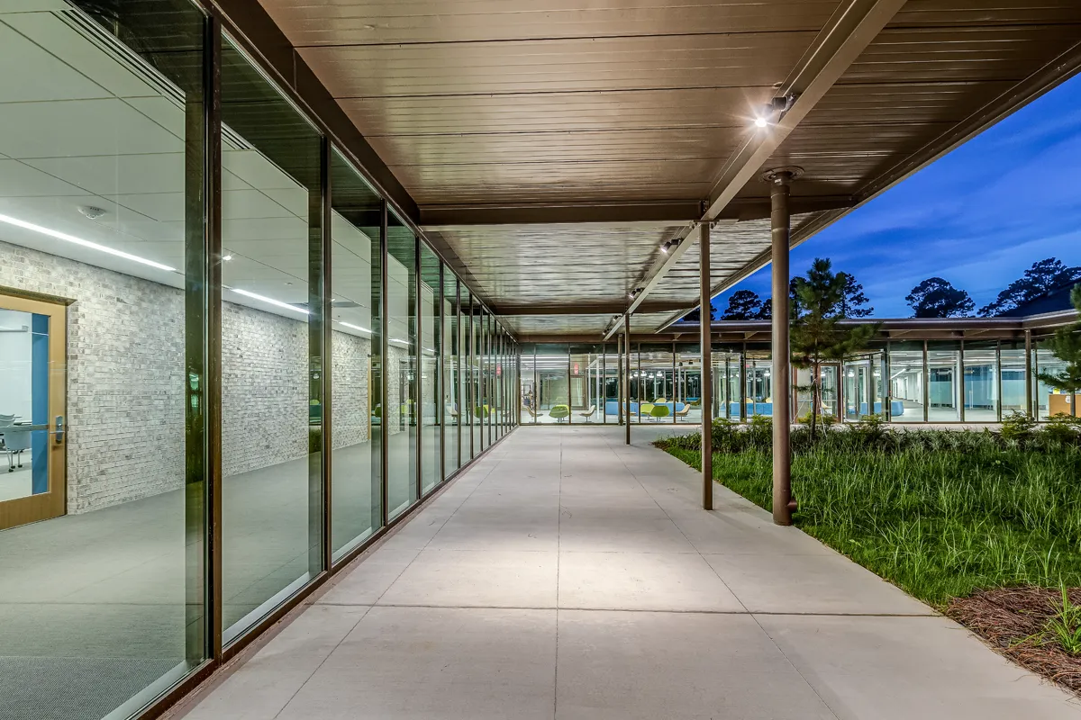 View of the lobby and study areas through the windows surrounding the Jeter Courtyard at dusk