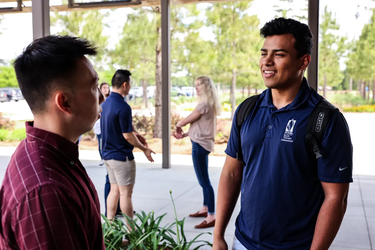 Students hanging out and talking outside of PCOM South Georgia