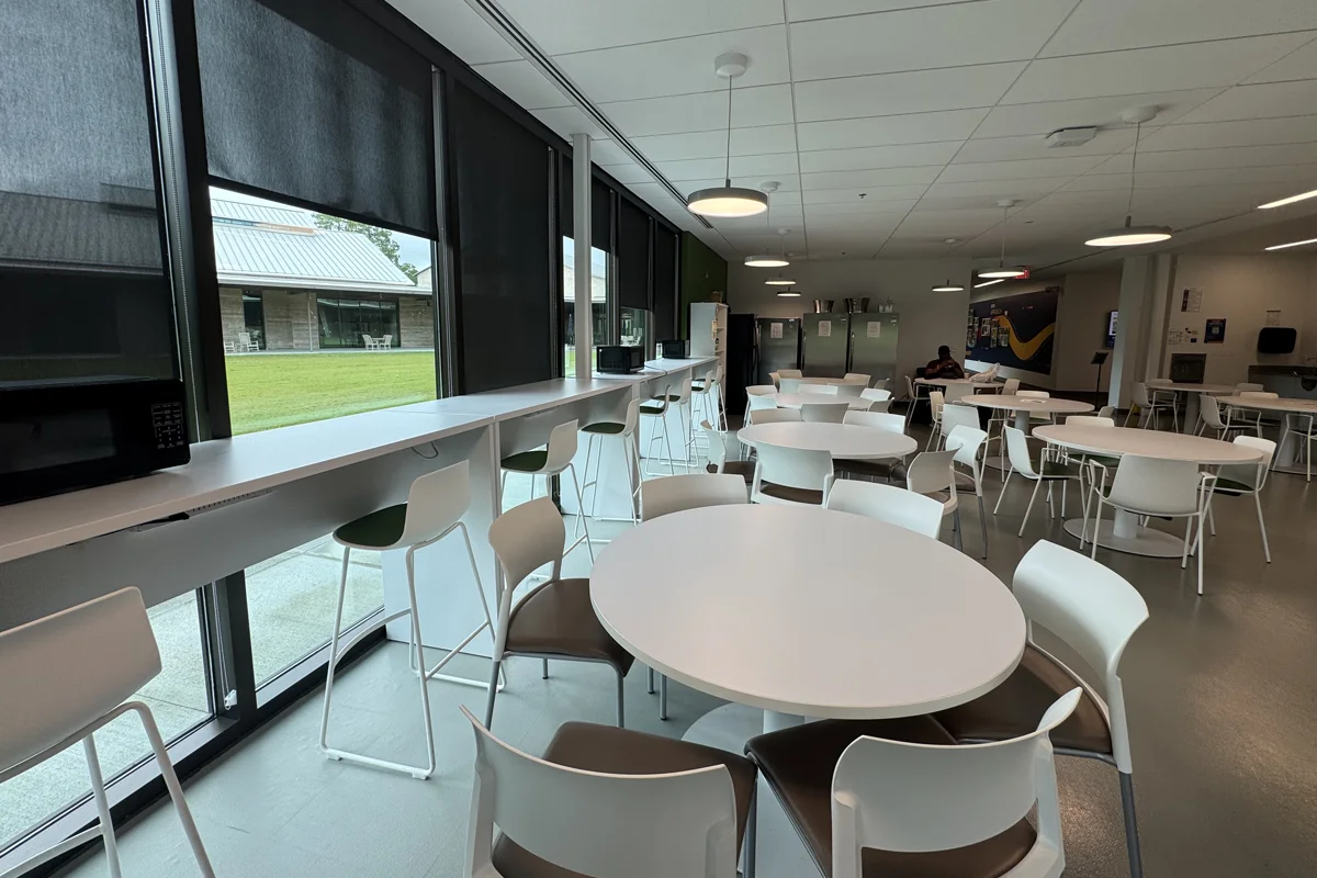 View of the long tables along the window of the student dining room