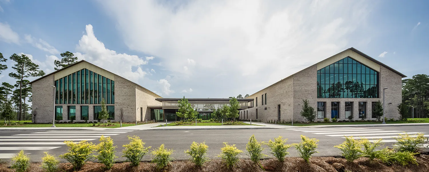 Wide view of the front of PCOM South Georgia's main building during daylight
