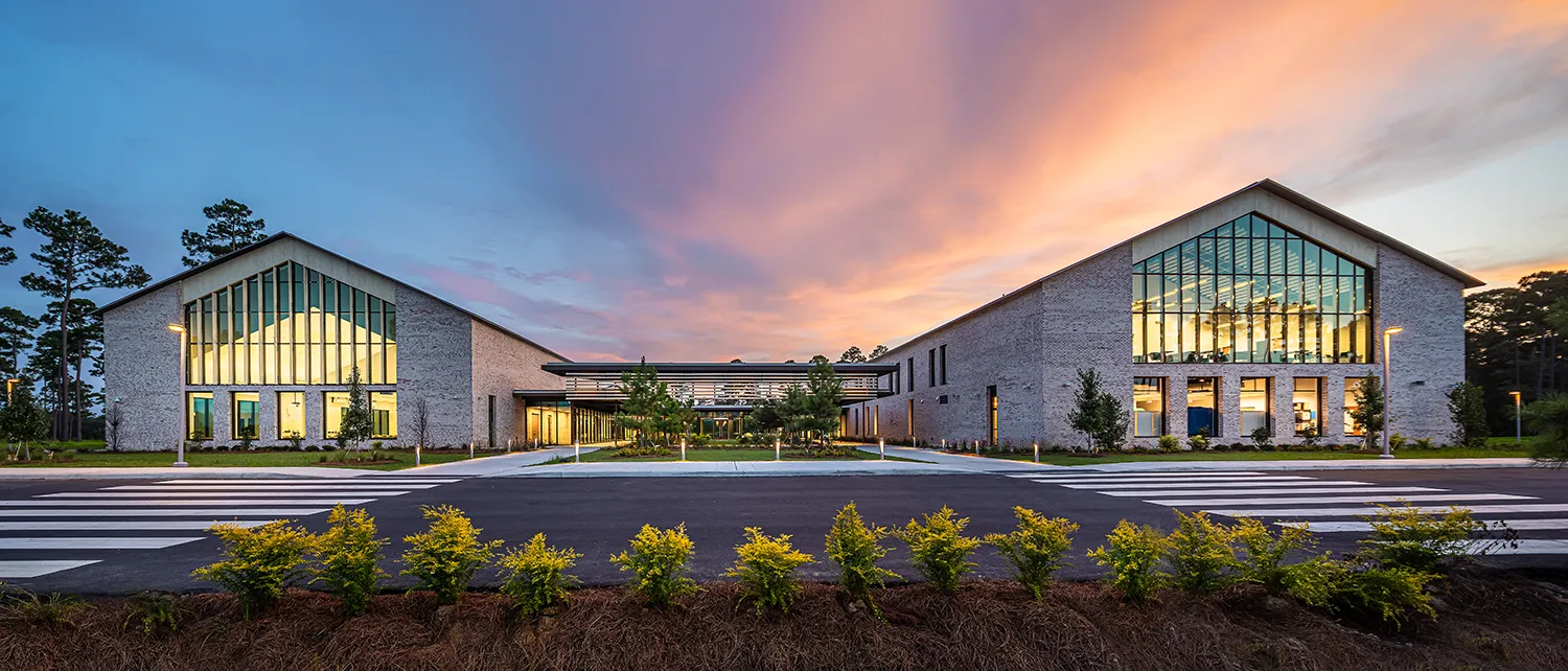 Wide view of the front of PCOM South Georgia's main building during dusk