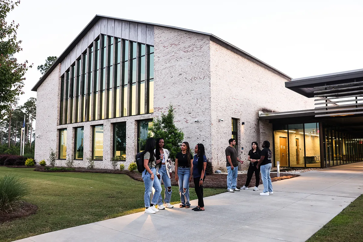 PCOM South Georgia students talking in front of the main building area