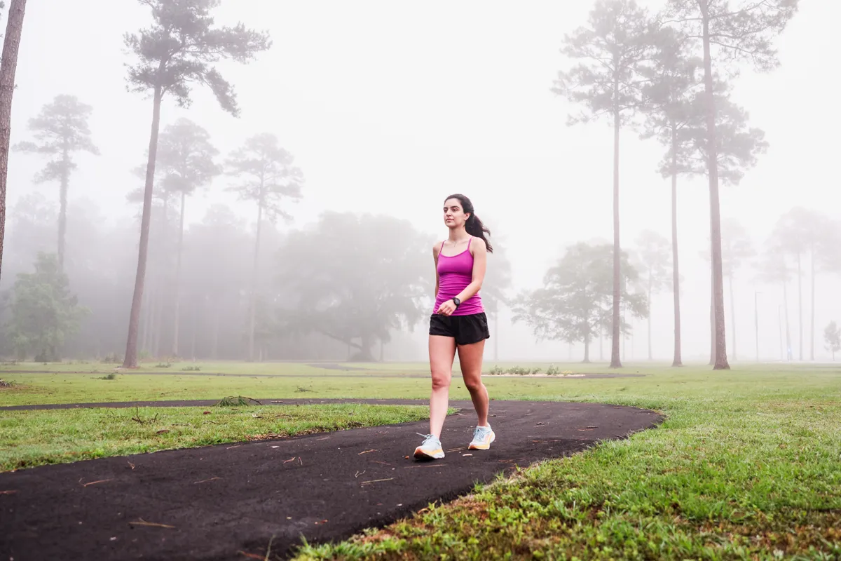 A student walks on the PCOM South Georgia fitness trail walking path