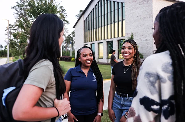 PCOM South Georgia students talking to guests during a campus tour event