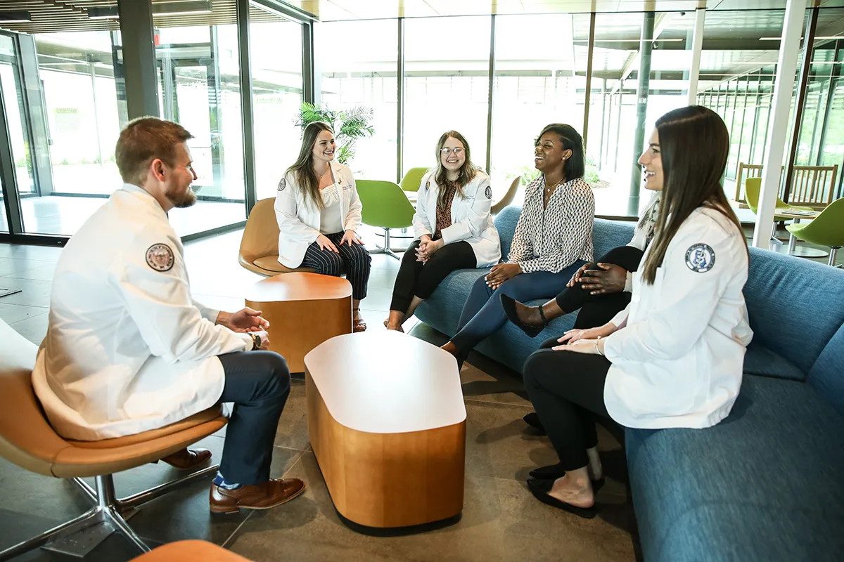 Med students chatting in the Colquitt Regional Connector Lobby