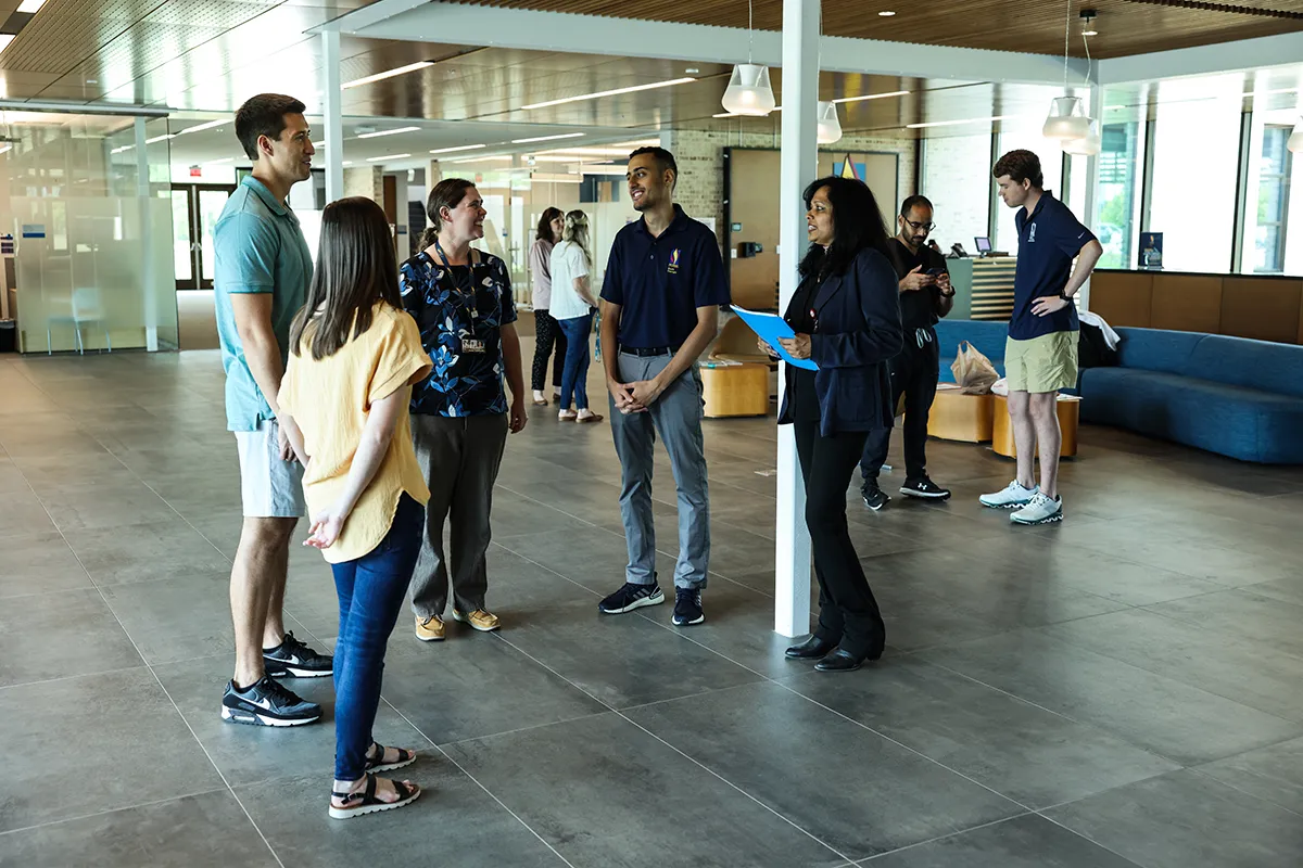 Grad and med students chatting in the Colquitt Regional Connector Lobby