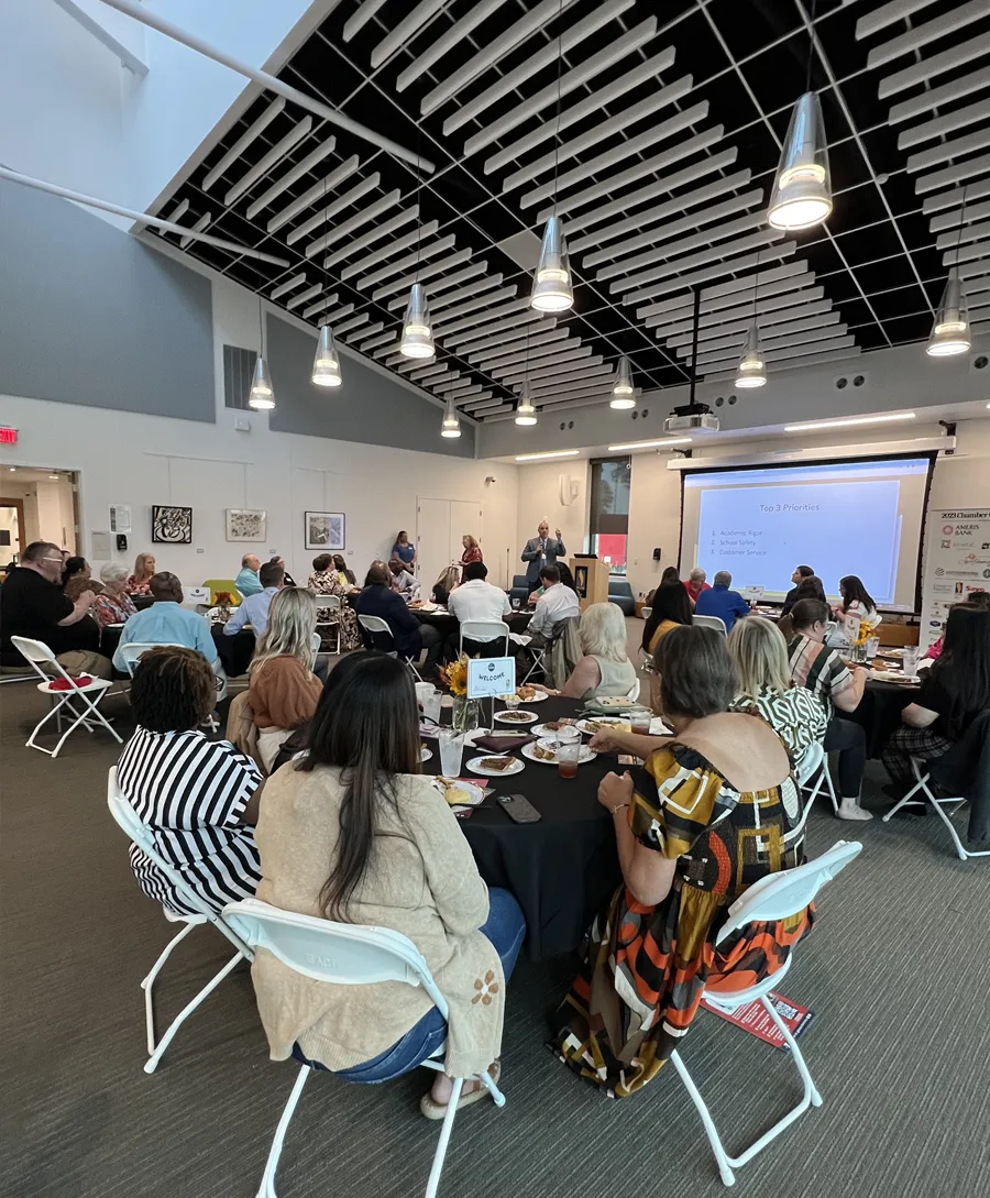 SGB/DeLoache room filled with tables, chairs and people for an event