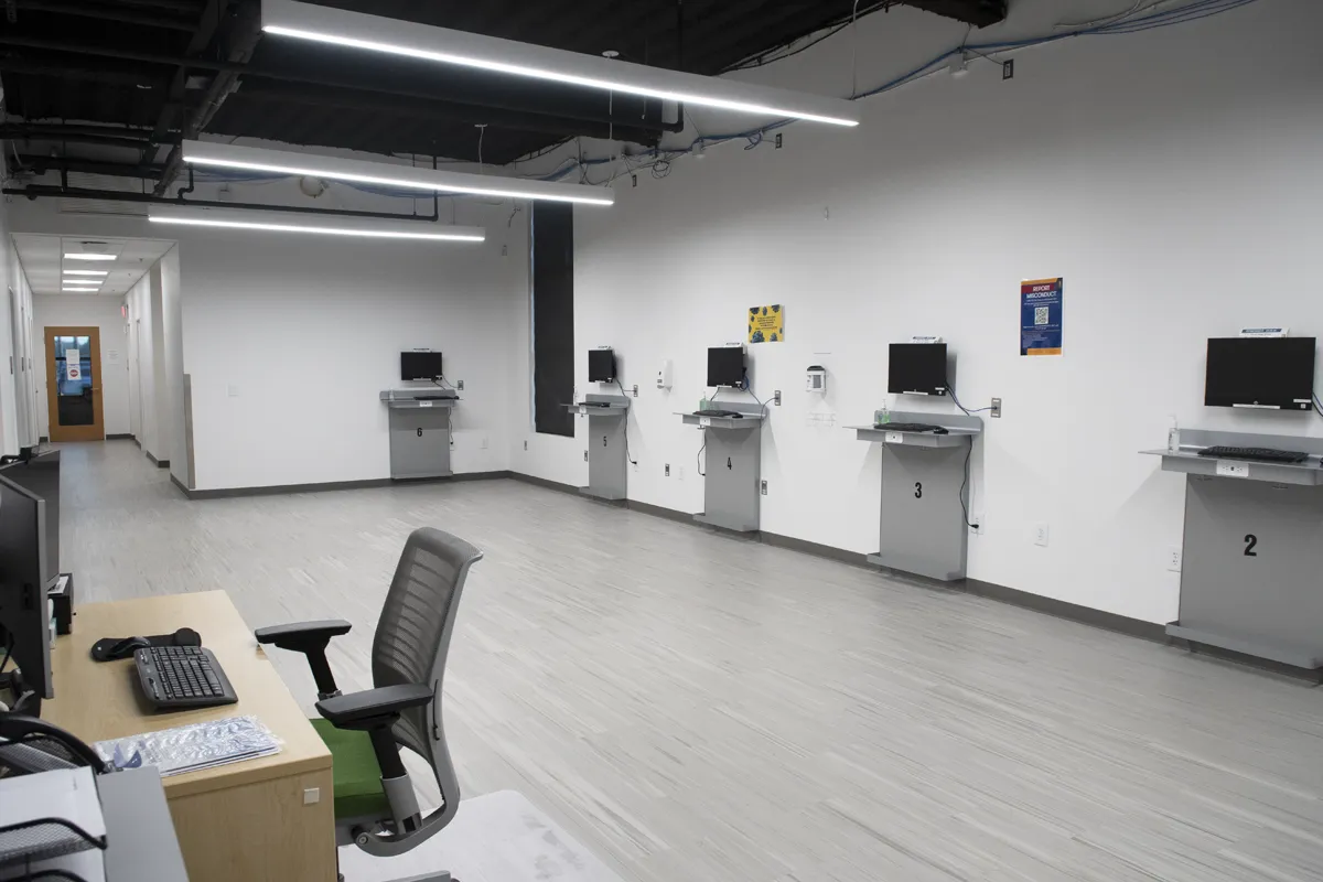 Computer terminals in a review area of the Sim Center