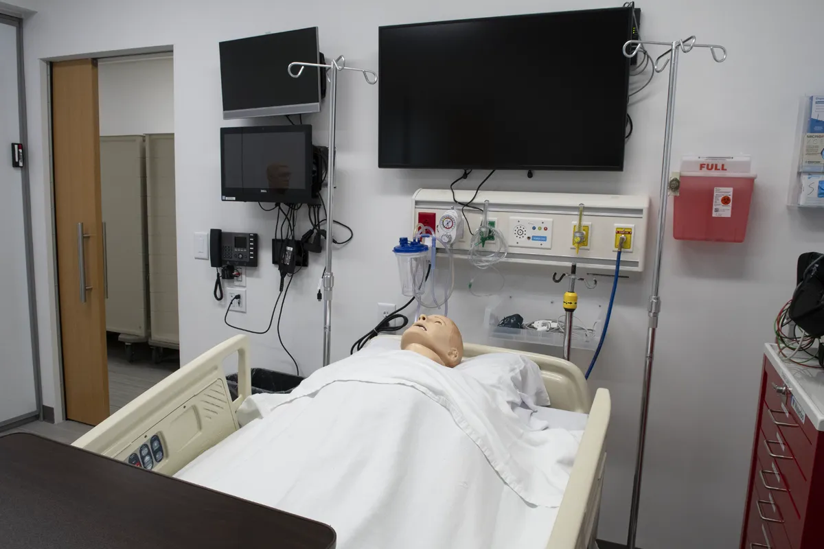 Patient mannequin lying in a hospital bed in the Simulation Center