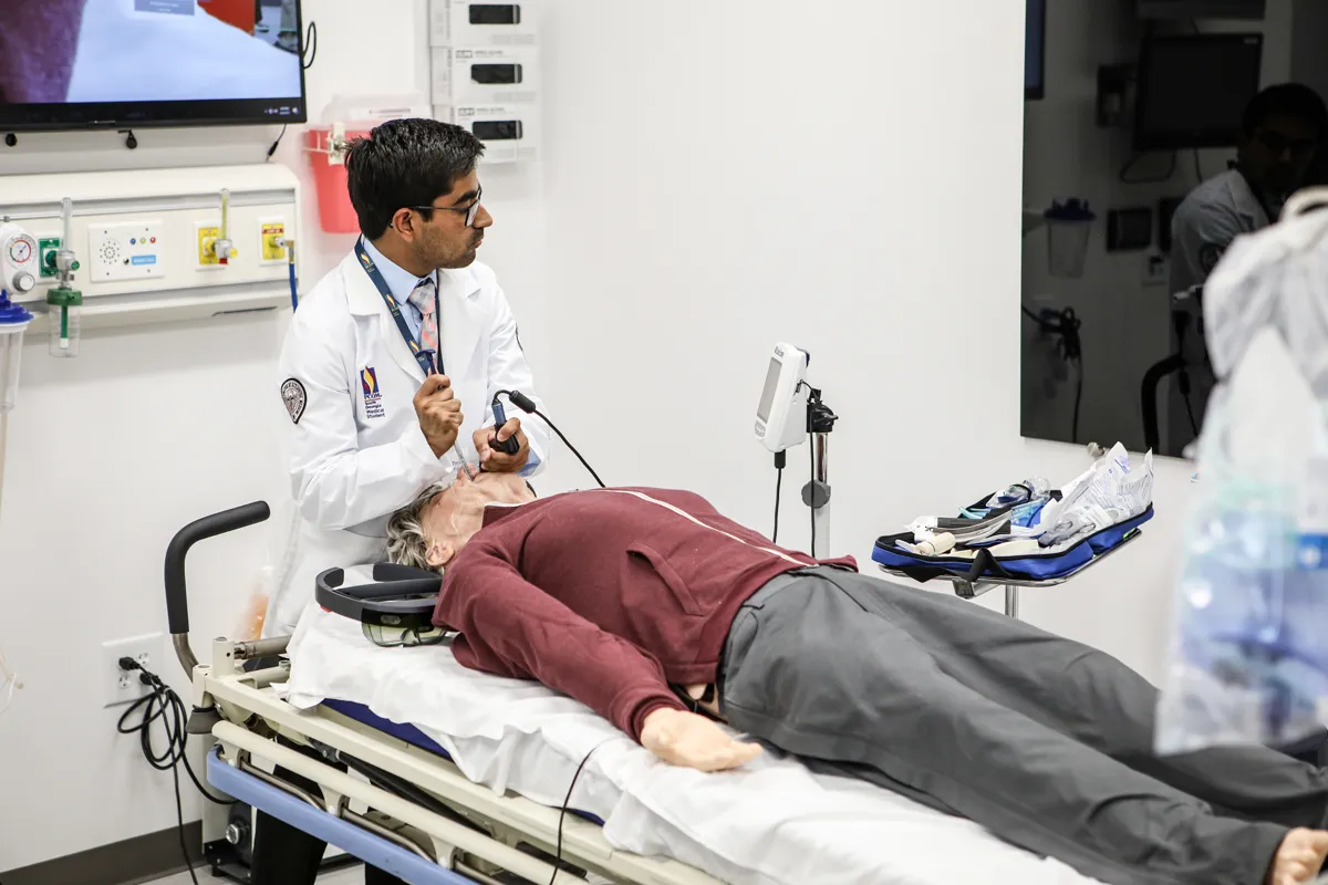 A med student practices opening airway procedures using equipment in the PCOM South Georgia Simulation Center