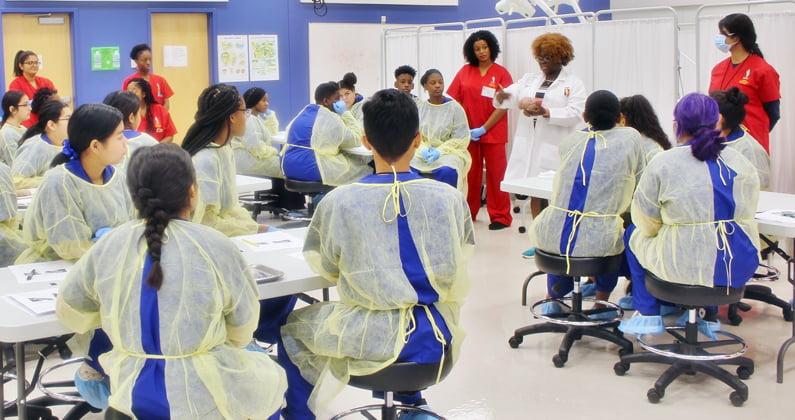 PCOM Georgia faculty and students show off a pig brain to high school students during an anatomy lesson as part of a summer camp program.
