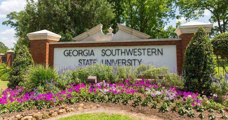 Front brick and stone college sign reading Georgia Southwestern State University with flowers in front.