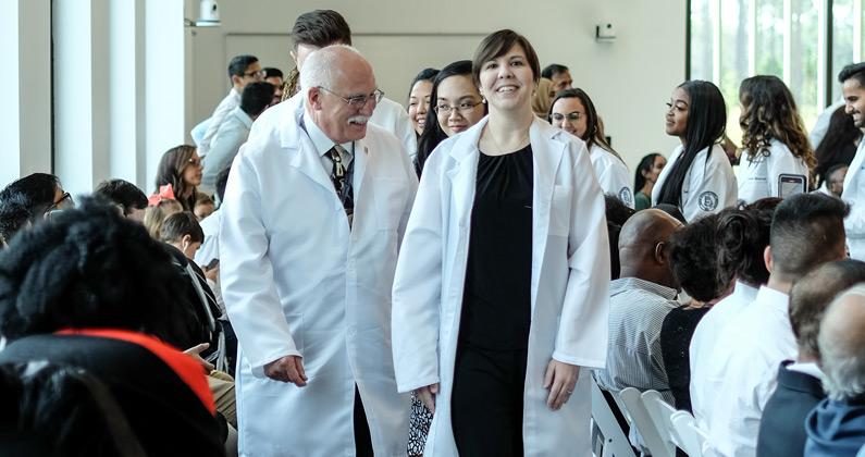 Dr. Petree walks alongside faculty and students during the White Coat Ceremony at PCOM South Georgia in 2019.