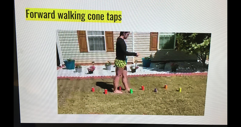 A PCOM Georgia student walks through a pattern of beverage cans in her yard to demonstrate the "forward walking cone taps" exercise.