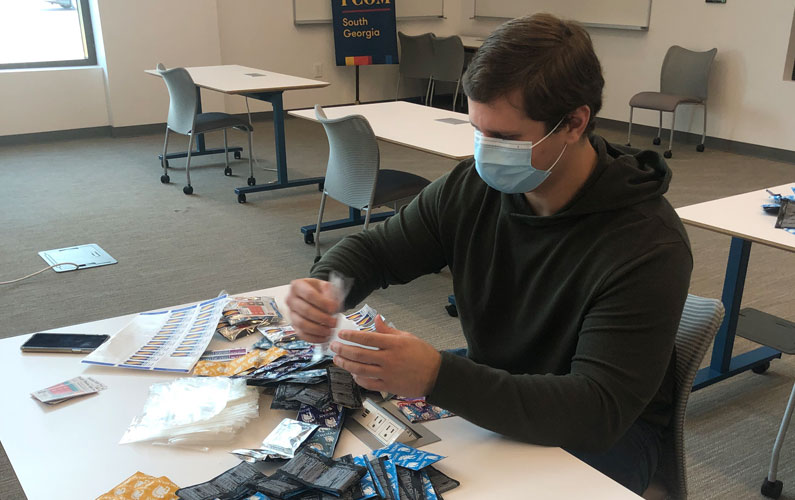 A PCOM South Georgia medical student puts together materials promoting sexual health in rural Georgia counties.