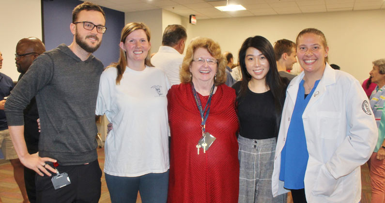 Mary Owen smiles with medical students in a group photo.