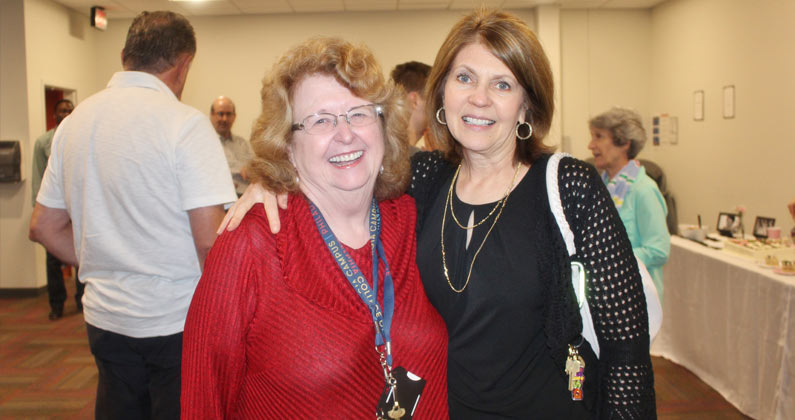 Dr. Owen and a colleague smile during an event at PCOM Georgia.