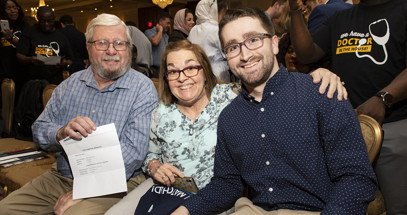 A PCOM medical student celebrates his residency match with his family for Match Day 2022.